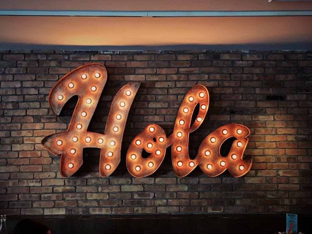 Neon sign saying 'hola'
