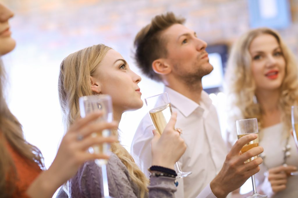 Group of people sipping champagne at an in-person event